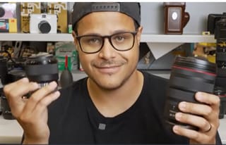 Camera Academy - person with camera lenses in hand